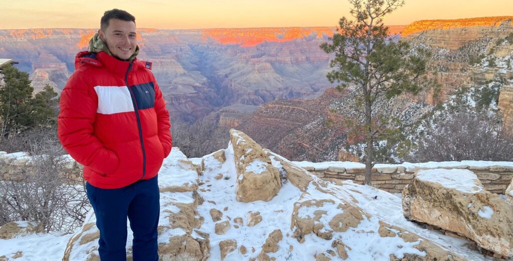 Picture of Daniel standing on a cliff face